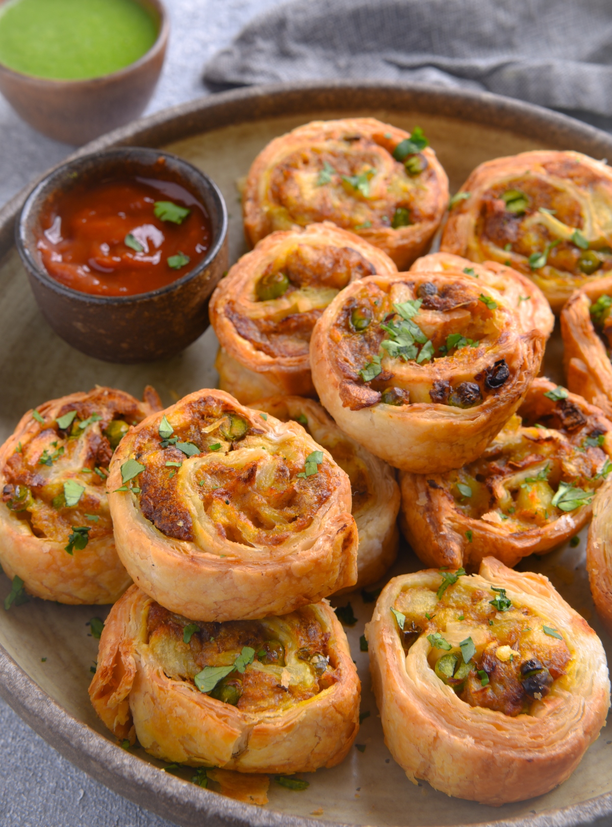 Air fryer samosa pinwheels are a delicious snack. Crispy puff pastry exterior, with a filling of spicy potato masala inside, makes it appealing to all. Vegan and delicious!