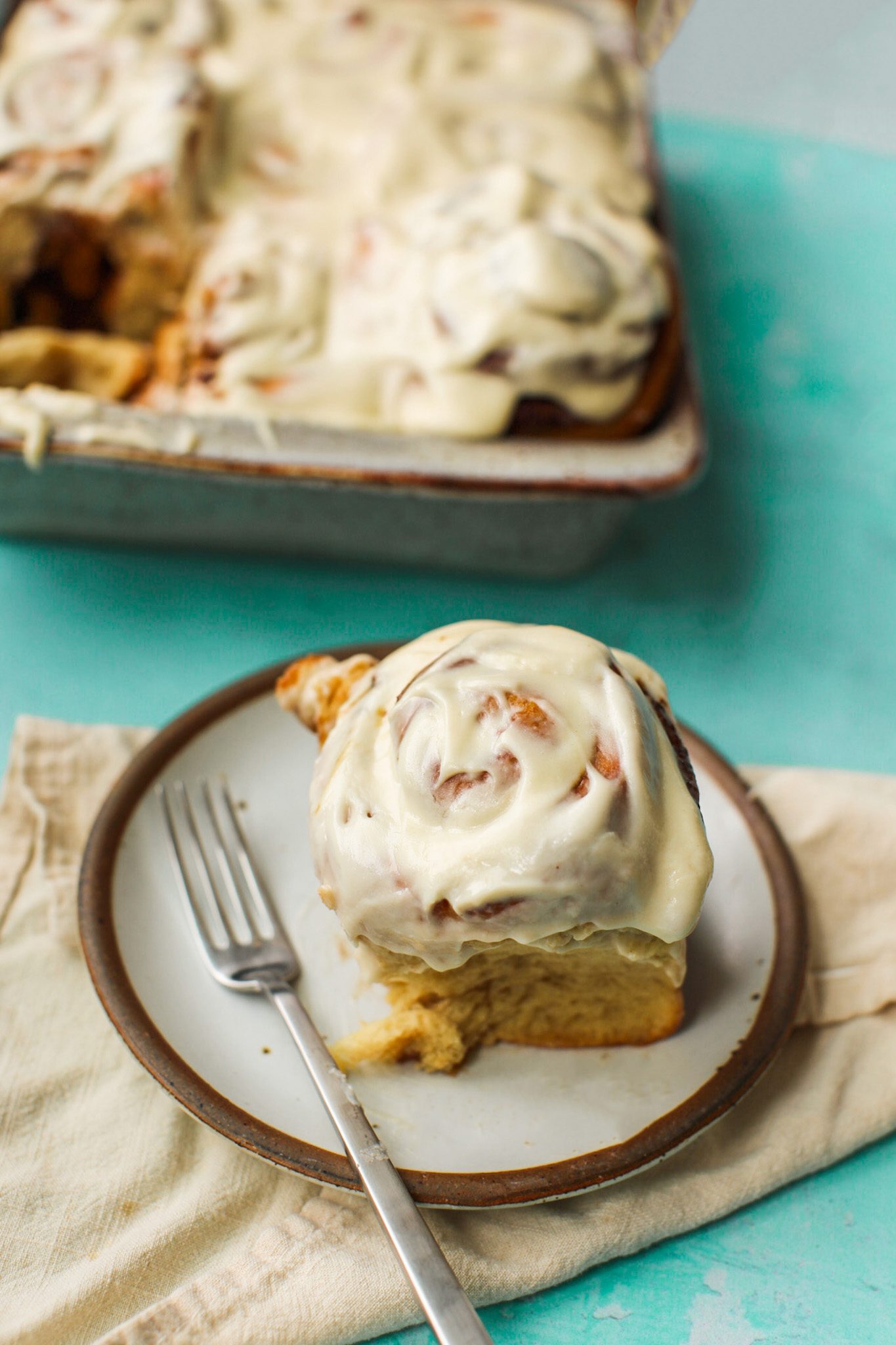 Fluffy vegan cinnamon rolls with cinnamon-sugar swirls and creamy vegan cream cheese frosting.