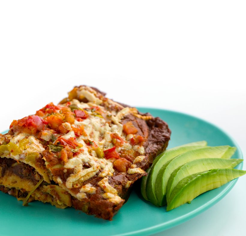Baked vegan enchiladas filled with finely chopped broccoli and black beans, coated in homemade enchilada sauce.