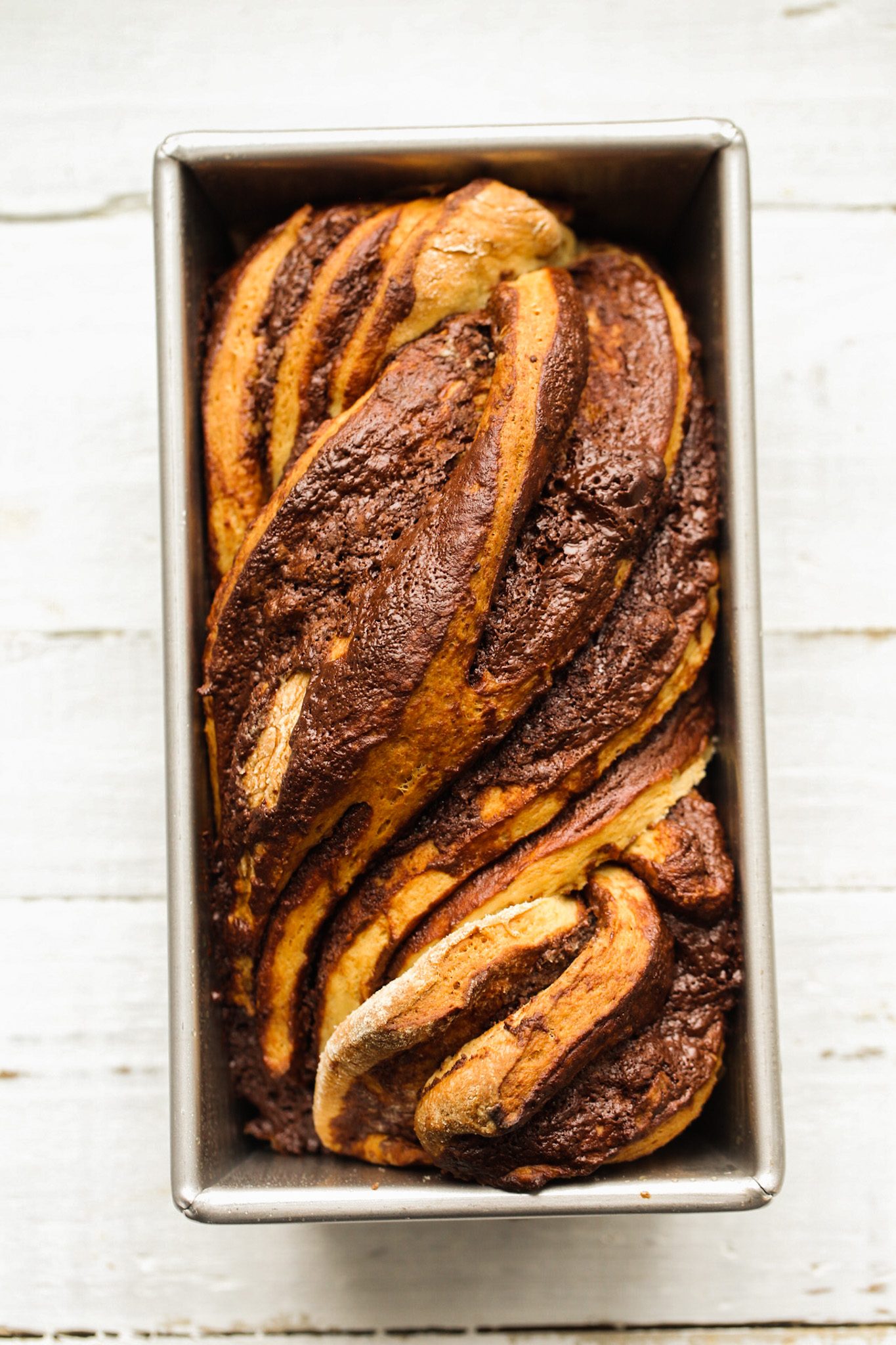Vegan chocolate babka with rich chocolate swirls woven through fluffy, golden baked dough.