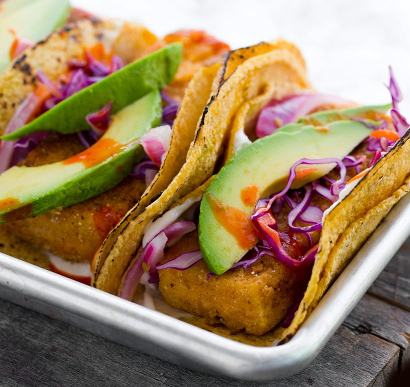 Crispy beer-battered tofu in corn tortillas topped with avocado, pickled onions and crunchy red cabbage.