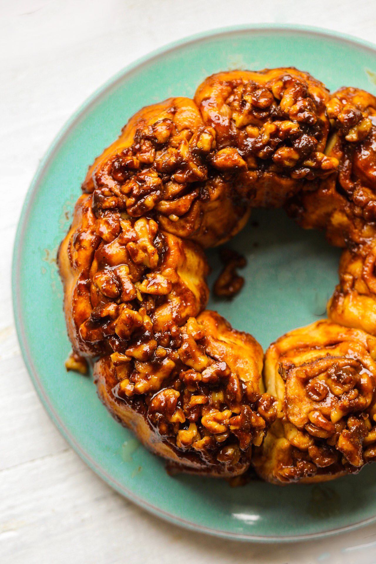 Fluffy cinnamon-swirled sticky buns topped with chopped walnuts and a sweet coconut sugar glaze.