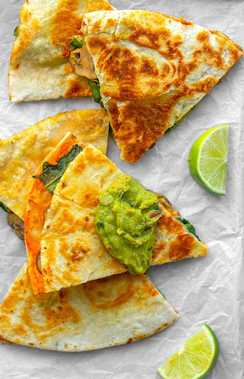 Toasted tortilla triangles filled with mushrooms, spinach and vegan queso, served with chunky guacamole.