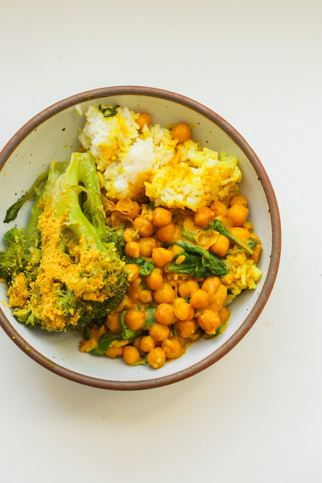 Fluffy rice bowls with chickpeas, broccoli and beets coated in a creamy peanut sauce.