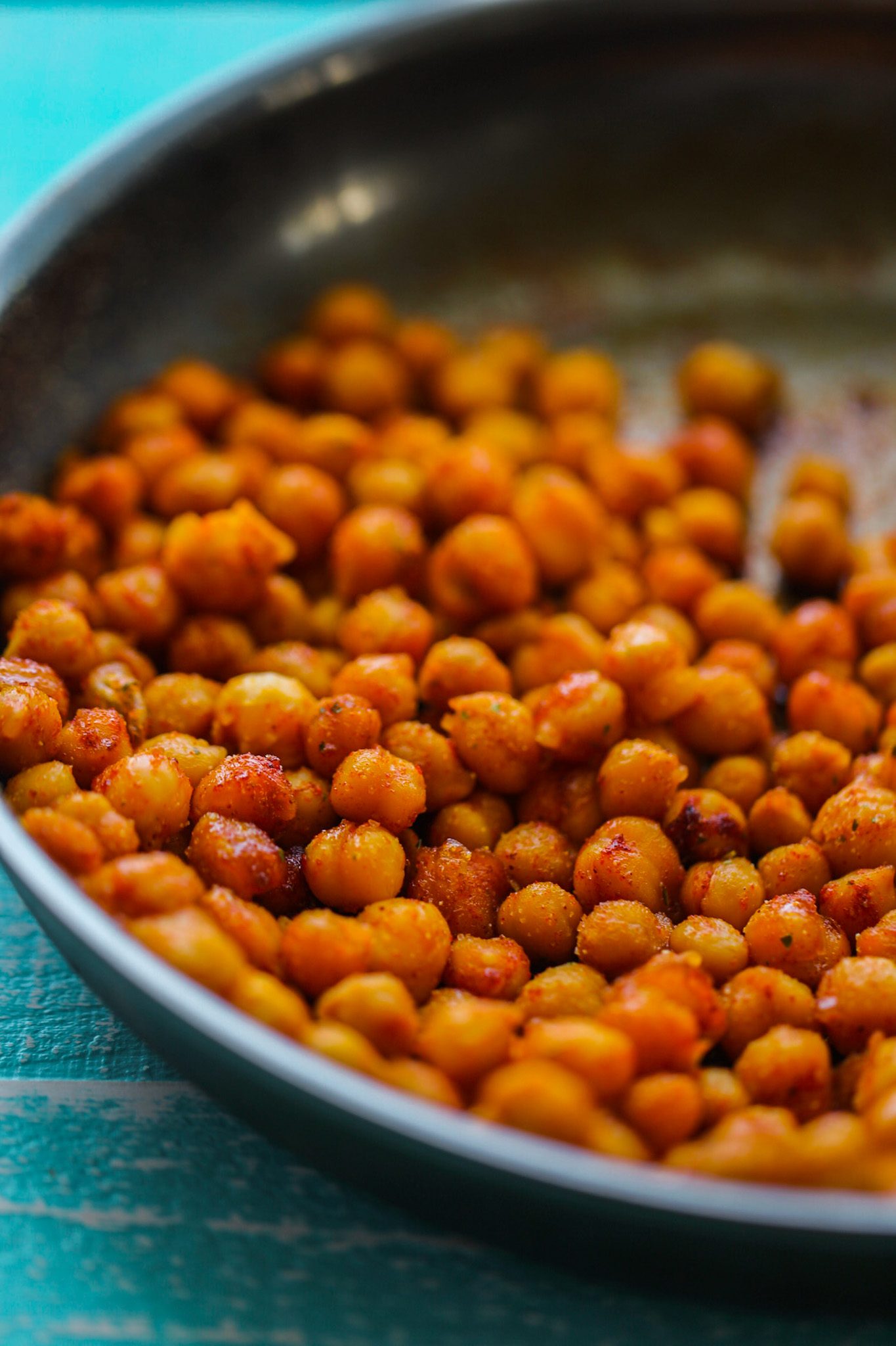 Sweet and smoky skillet chickpeas with caramelized edges and a reddish paprika coating.