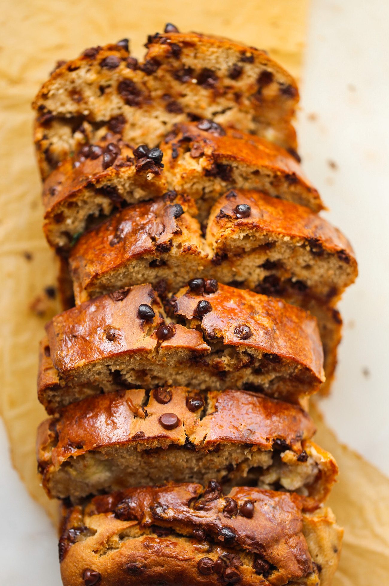 Slices of fluffy vegan banana bread made with chickpeas and studded with chocolate chips.