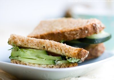 Bite-sized cucumber mint tea sandwiches on spelt bread with fresh herbs and a sweet, spicy maple wasabi spread.
