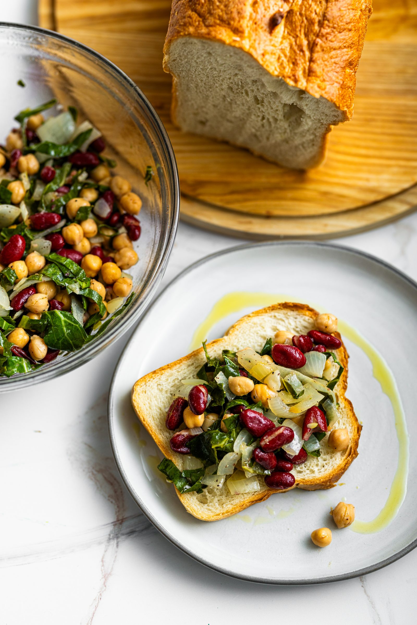 Kidney and garbanzo bean salad with chopped collard greens and sautéed onions in a tangy lemon and vinegar dressing.