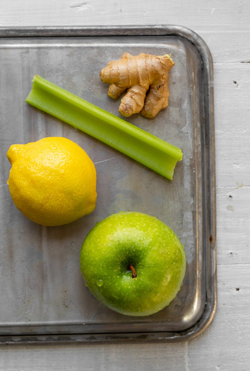 Bright green juice made with green apple, ginger, and celery, with an optional sprinkle of cayenne on top.