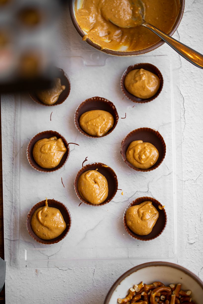 Vegan chocolate peanut butter cups with creamy peanut butter centers and festive Halloween sprinkles.
