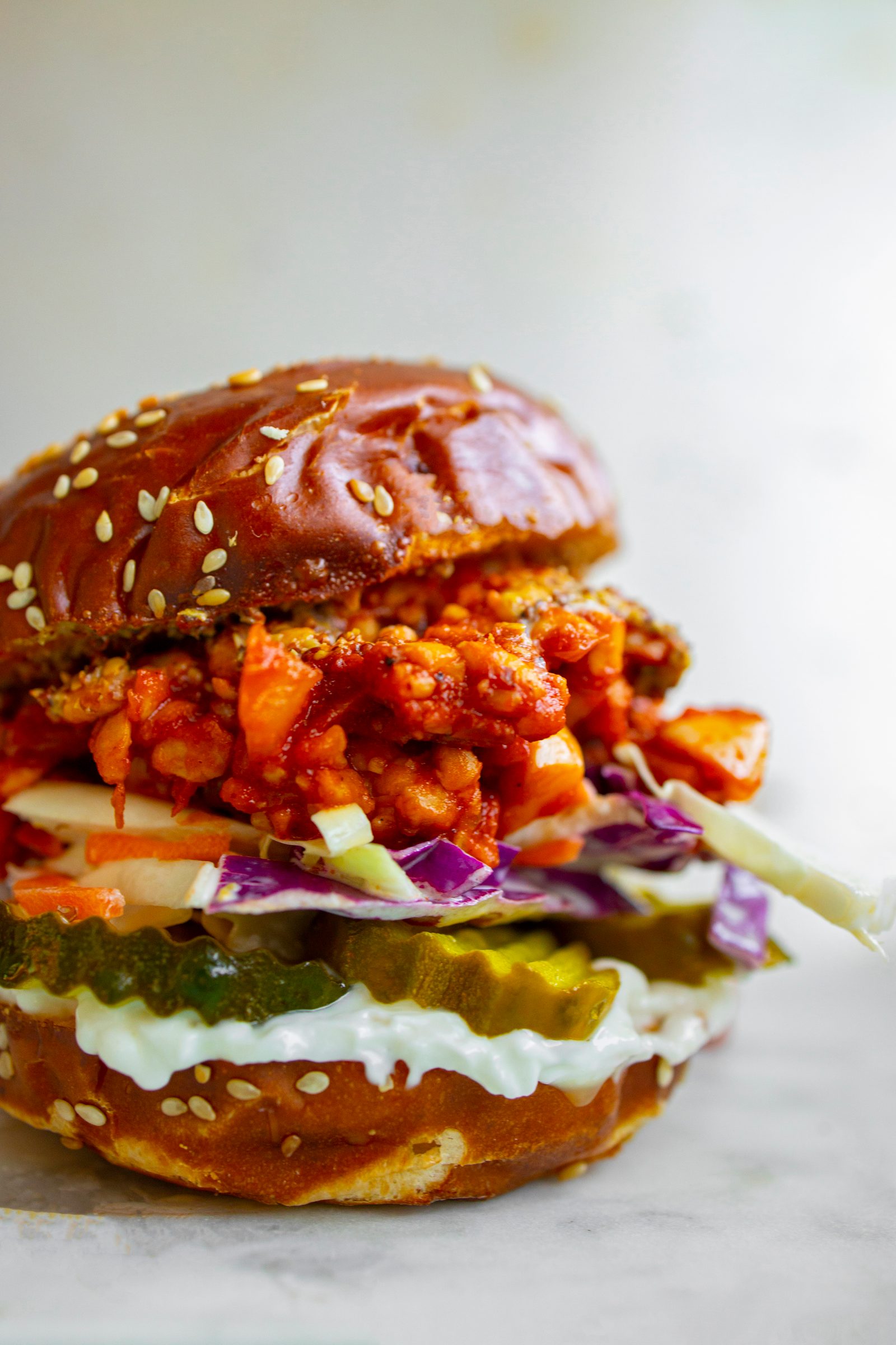 Tempeh sloppy joes with a rich tomato filling, served on pretzel buns with vegan cole slaw.