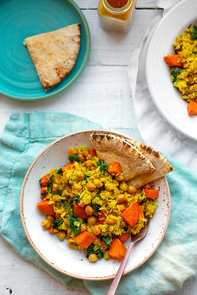 Coconut curry rice bowl with fluffy jasmine rice, chickpeas, sweet potato, spinach and garlic.