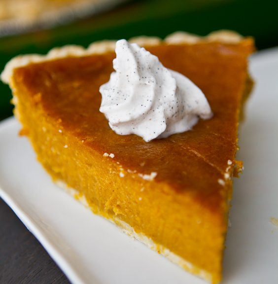 Vegan pumpkin pie with a rich pumpkin spice and maple filling, topped with vanilla bean coconut whip.