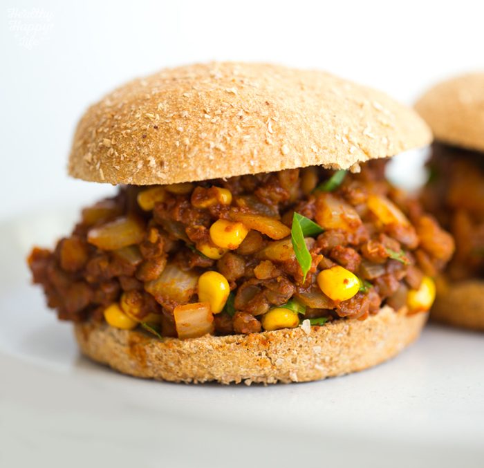 Vegan sloppy joes with lentils, corn, and collard greens in a spiced tomato sauce served on hamburger buns.