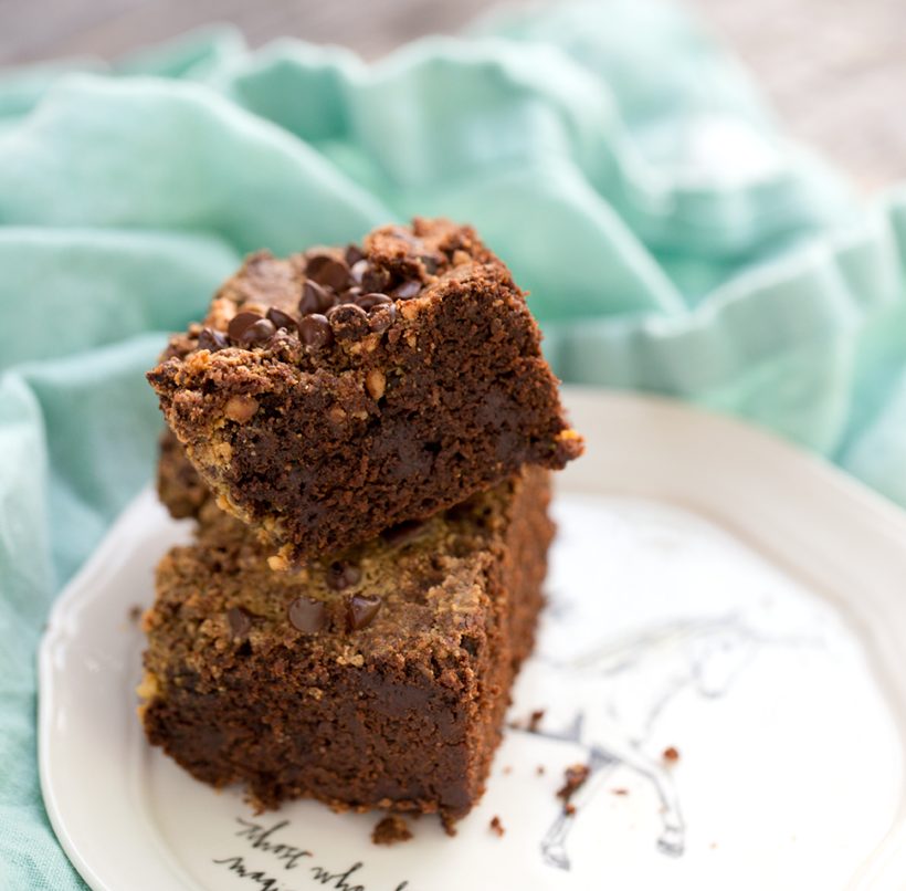 Fudgy chocolate sweet potato brownies made with buckwheat flour, with peanut butter crumbling on top and around the edges.