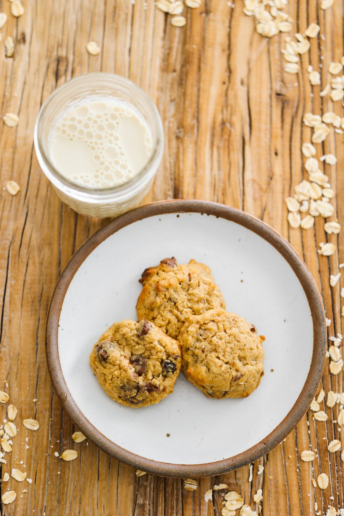Fluffy, chewy vegan oatmeal cookies studded with chopped raisins and dark chocolate.