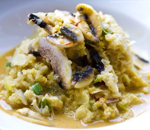 Creamy almond and coconut quinoa risotto with scallions and spicy-sweet saffron mushroom gravy.