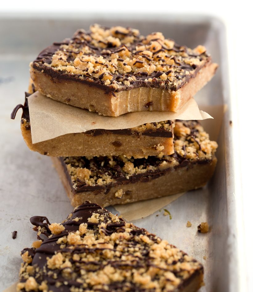 No-bake peanut butter cookie dough bars with chocolate and a peanut butter crumble topping.