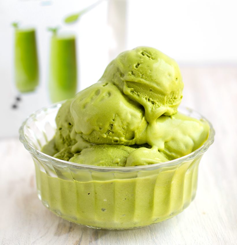 Creamy pastel-green scoops of coconut milk matcha ice cream served in a bowl.