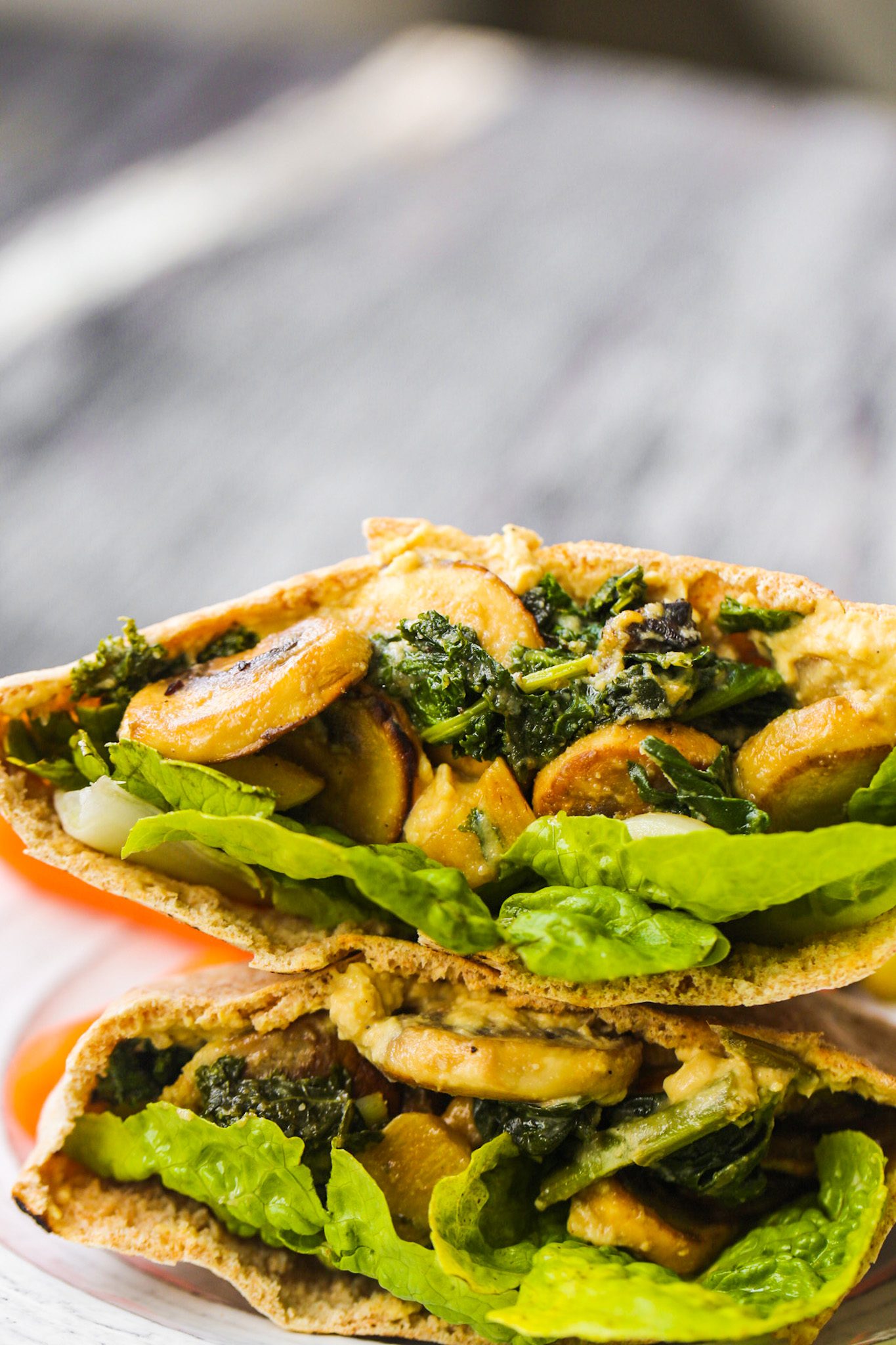 Warm pita pockets stuffed with garlicky mushrooms, wilted kale, hummus, and crisp romaine lettuce.