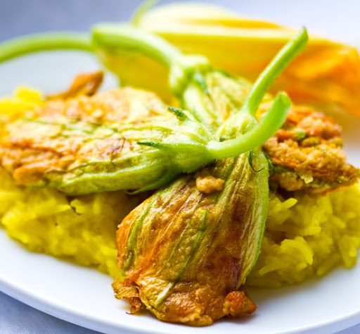 Lightly fried squash blossoms stuffed with vegan cashew ricotta and served with sweet saffron rice.