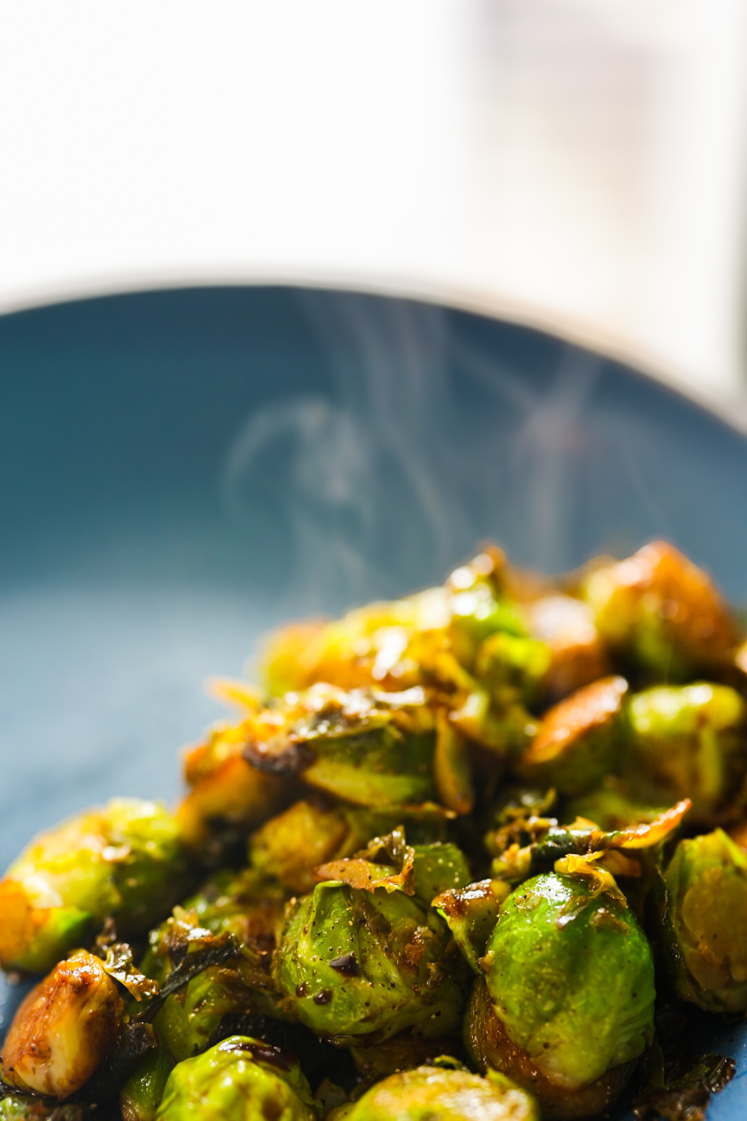 Tender Brussels sprouts with caramelized edges, a glossy balsamic glaze, and cracked black pepper.