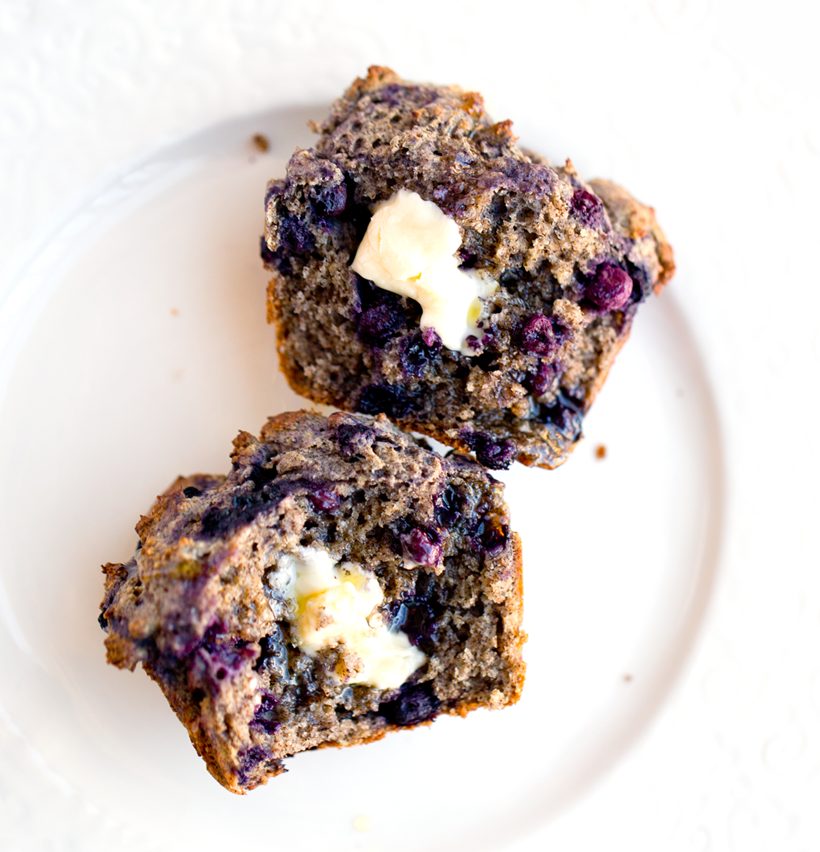 Fluffy blueberry buckwheat muffins with browned tops and blueberries in every bite.