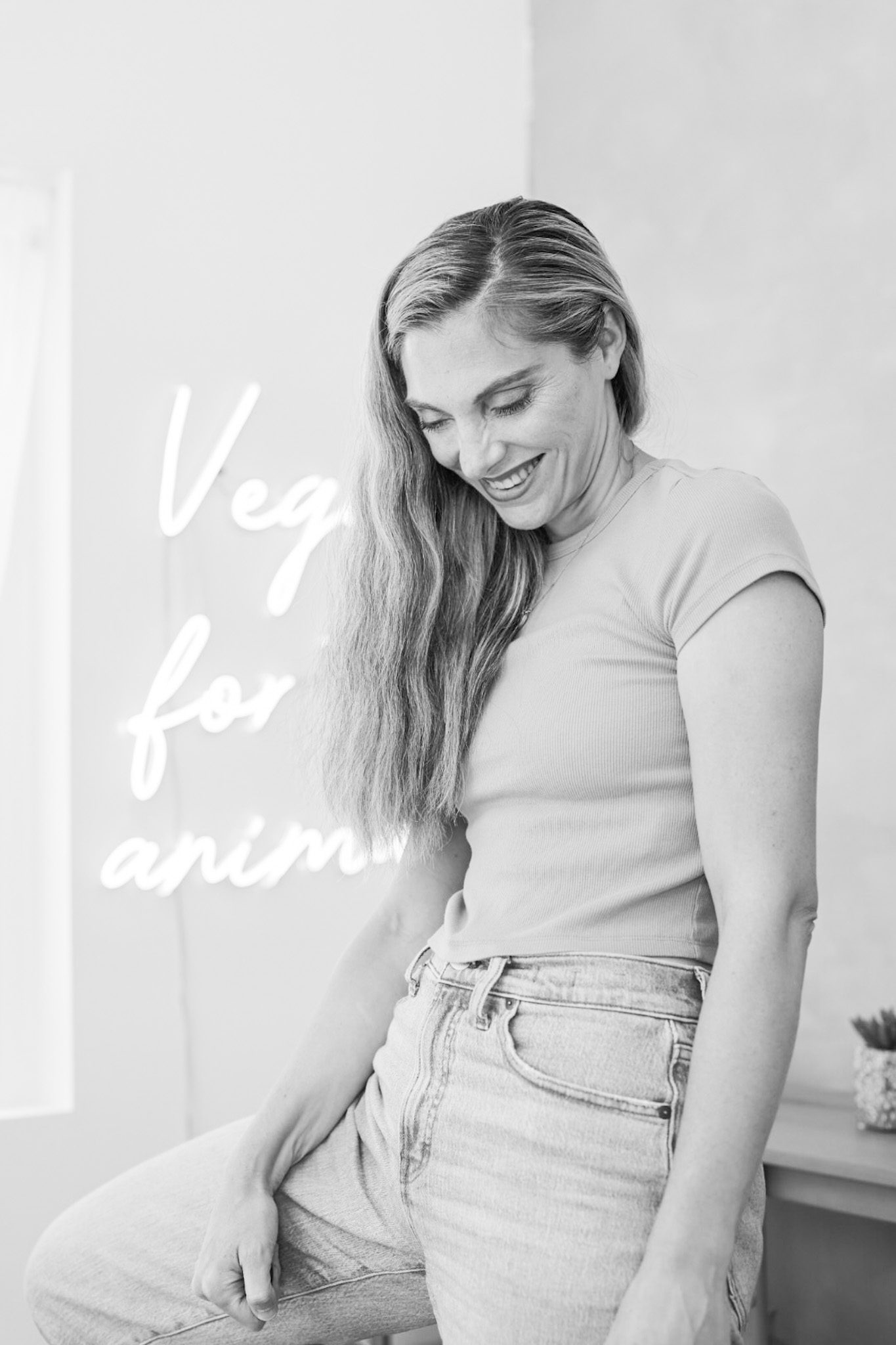 Kathy Patalsky holds a vegan-for-the-animals sign in a post sharing 15 tips for going vegan.