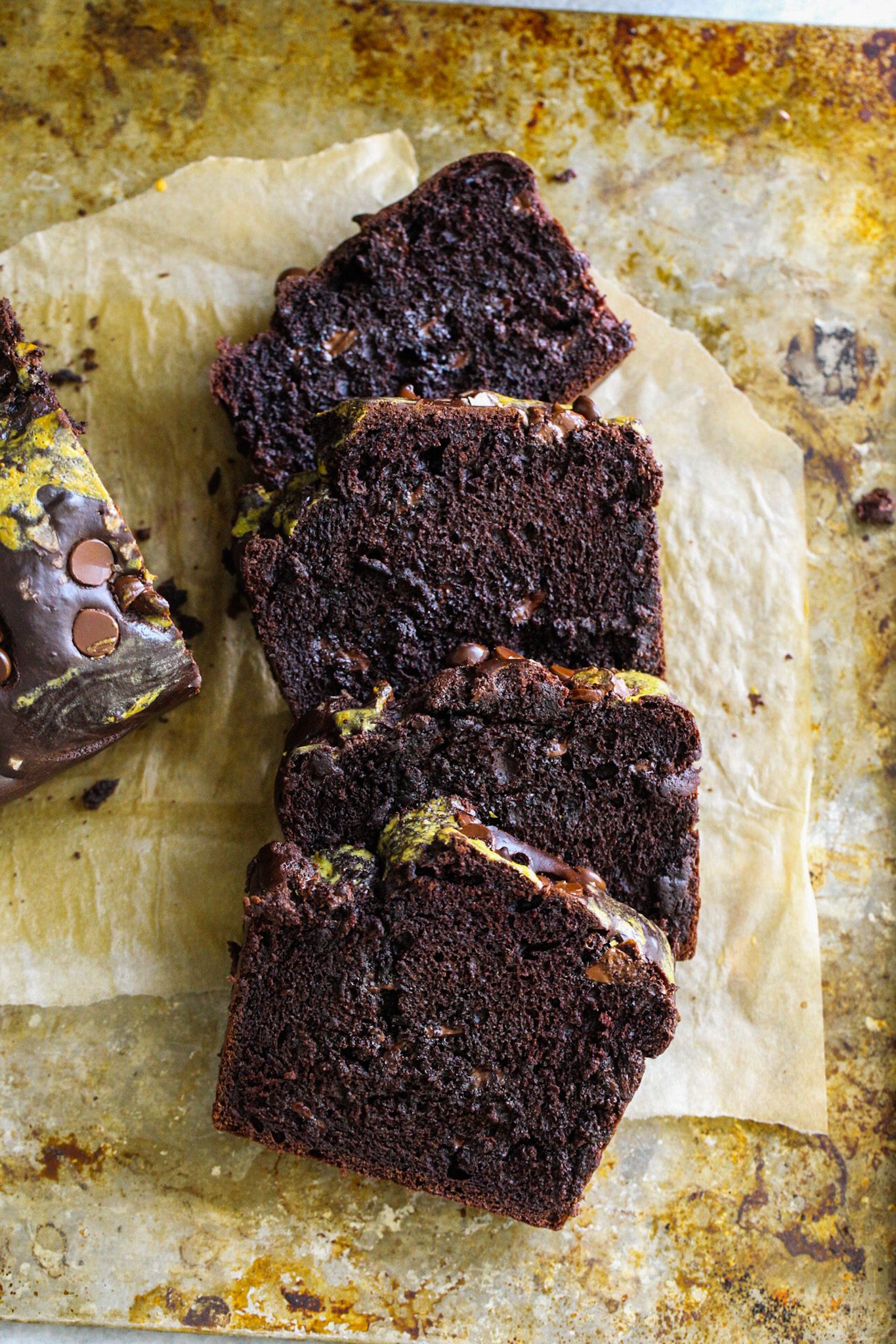 Thick slices of fluffy vegan double chocolate loaf studded with melty chocolate chips.