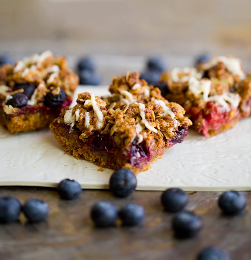 Raspberry blueberry bars with a fresh berry filling and cinnamon oat crumble topping.